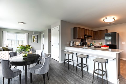 A modern kitchen with a dining table and chairs.