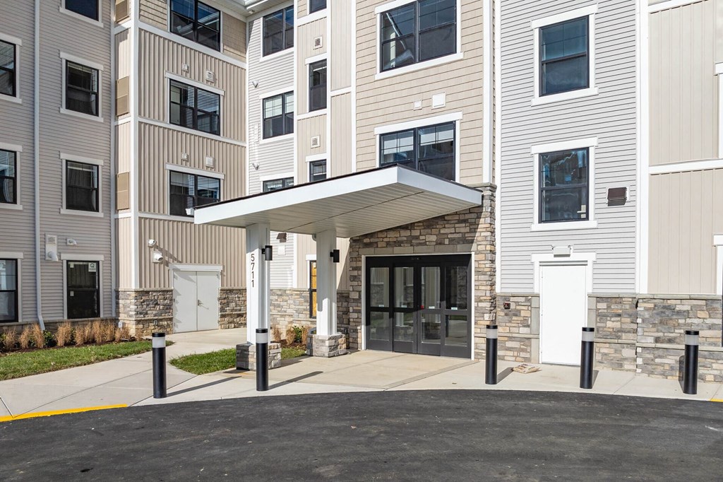 A building with a stone wall and a white door.