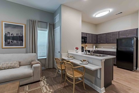 A modern kitchen with a dining table and chairs.