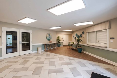 A spacious room with a tiled floor and a skylight.