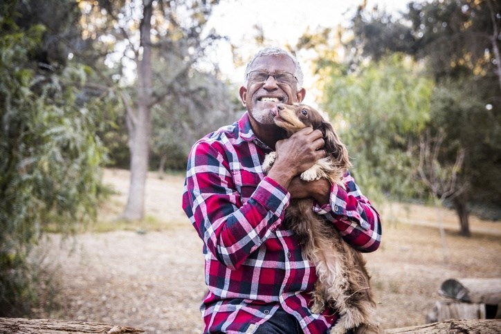 elderly man with dog outside