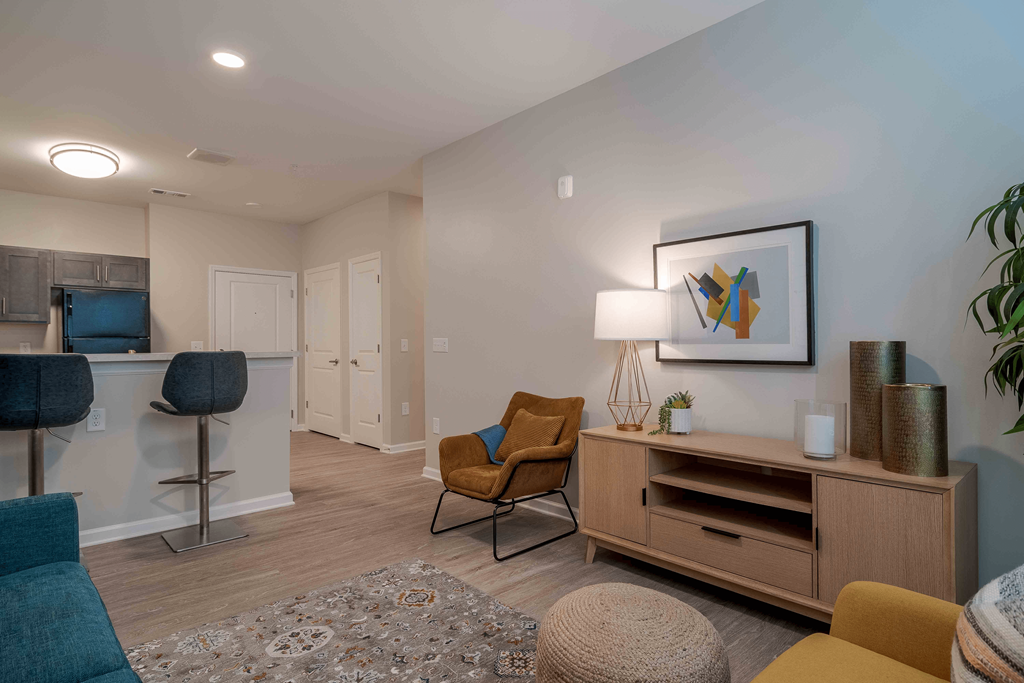A living room with a brown chair and a brown cabinet at Sweetwater Point in Douglasville, GA