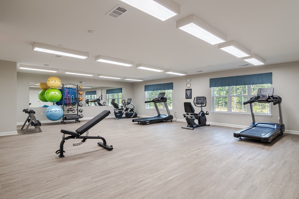 a gym with cardio machines and weights at Sweetwater Point in Douglasville, GA