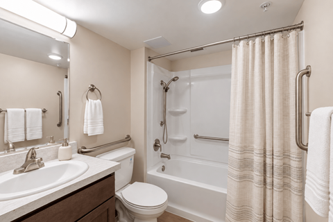 A bathroom with a toilet, sink, and bathtub.