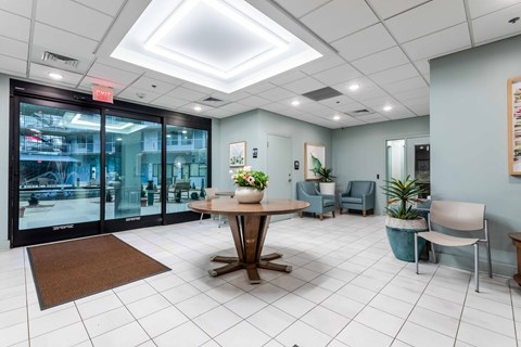 A room with a table and chairs in the middle of the room.
