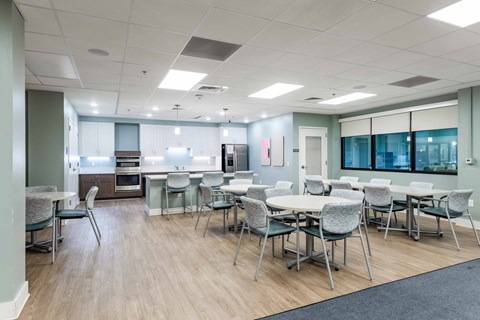 A conference room with a long table and chairs.