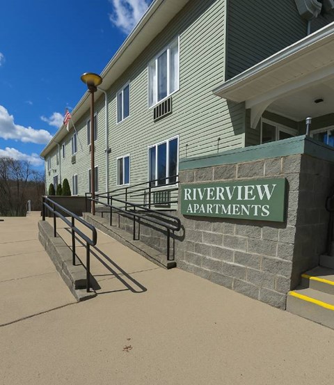 A building with the name Riverview Apartments on it.