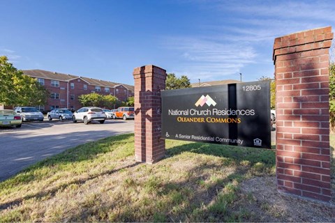 The sign in front of the brick wall reads "National Cut Residential Commons Oleaner Commons".