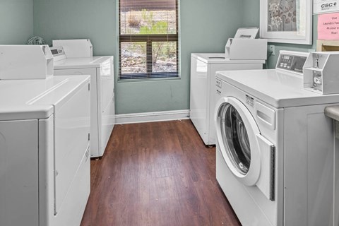 A laundry room with washers and dryers.