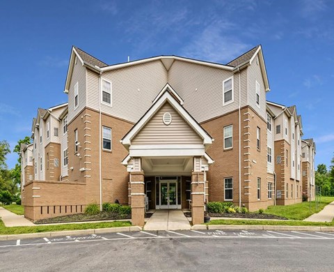 A large, multi-story building with a brick facade and a covered entrance.