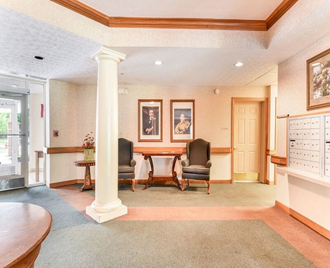 A room with a table and chairs in the middle.