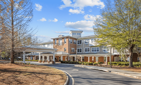 A large building with a curved driveway in front.
