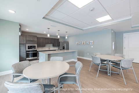A modern kitchen with a dining table and chairs.