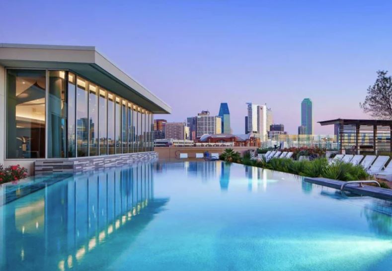 A long rectangular pool with a glass wall on one side.