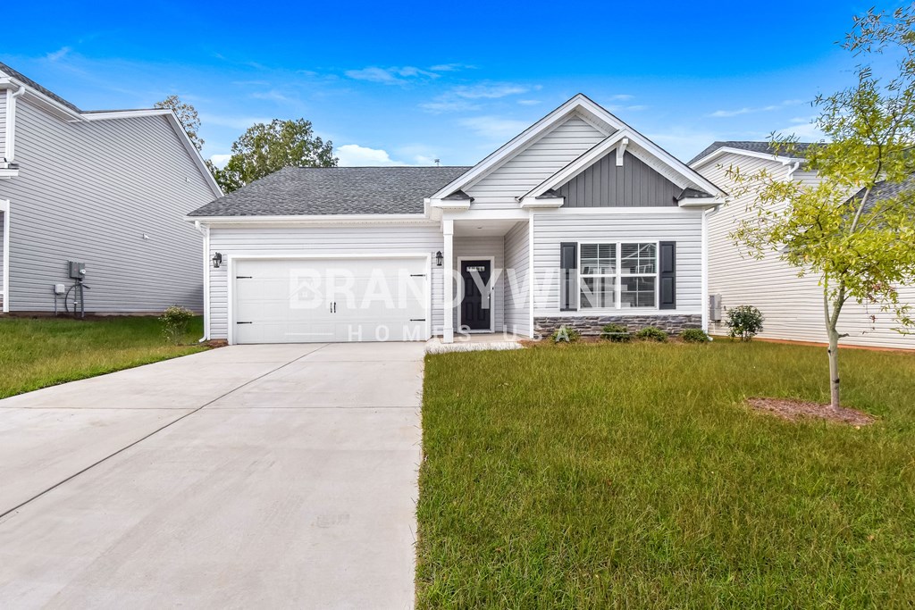 a white house with a white garage door and a driveway