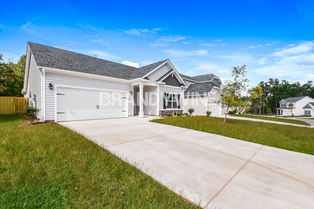 a white house with a driveway and a garage door