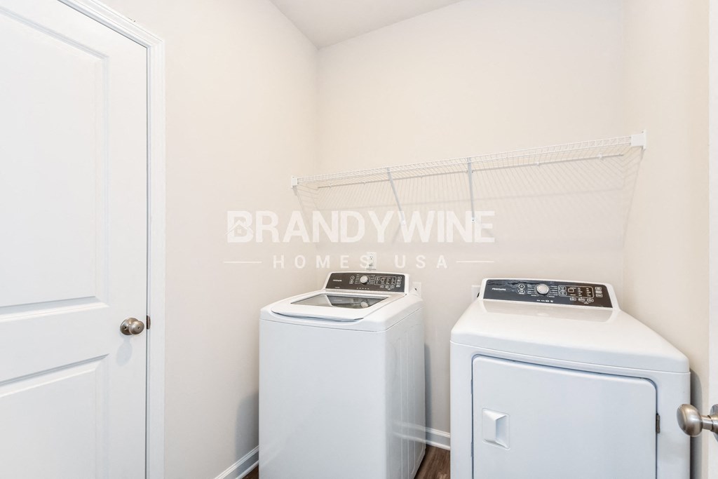 a white washer and dryer in a white laundry room