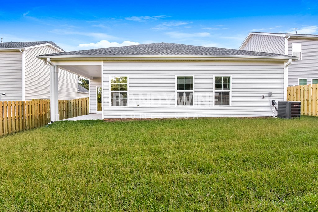 a white house with a yard in front of it