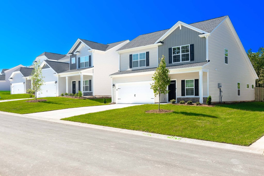 a large white house with a street in front of it