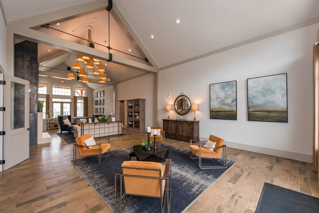 a large living room with a vaulted ceiling and hardwood flooring at The Whitworth, Williamsburg, VA