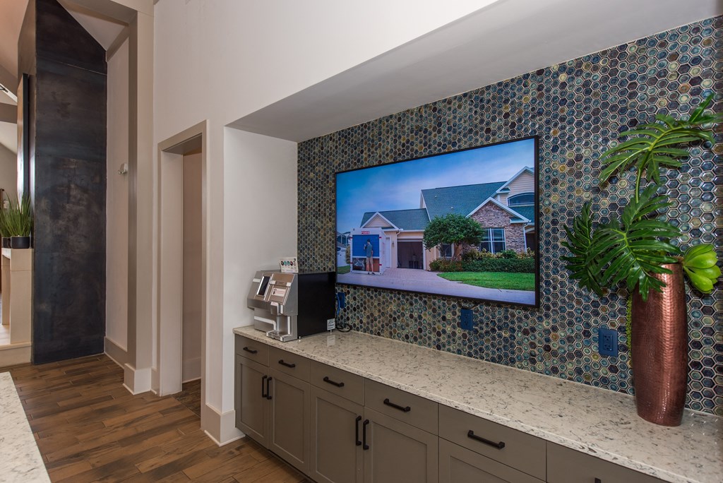 a home office with a large tv on the wall at The Whitworth, Williamsburg, 23185