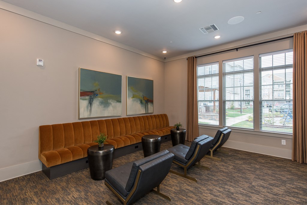 a room with a couch chairs and paintings on the wall at The Whitworth, Williamsburg, VA, 23185