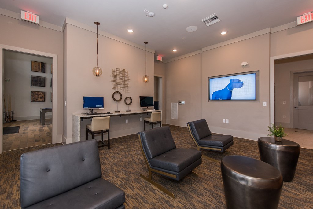 a room with couches and chairs and a tv on the wall at The Whitworth, Williamsburg, VA, 23185