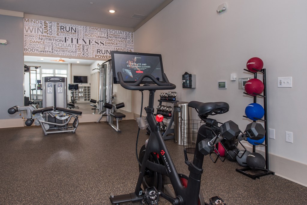 a spacious exercise room with cardio equipment and a treadmill at The Whitworth, Virginia, 23185