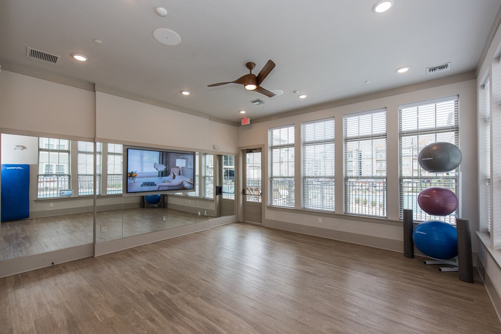 an empty room with a large window and a ceiling fan at The Whitworth, Virginia, 23185