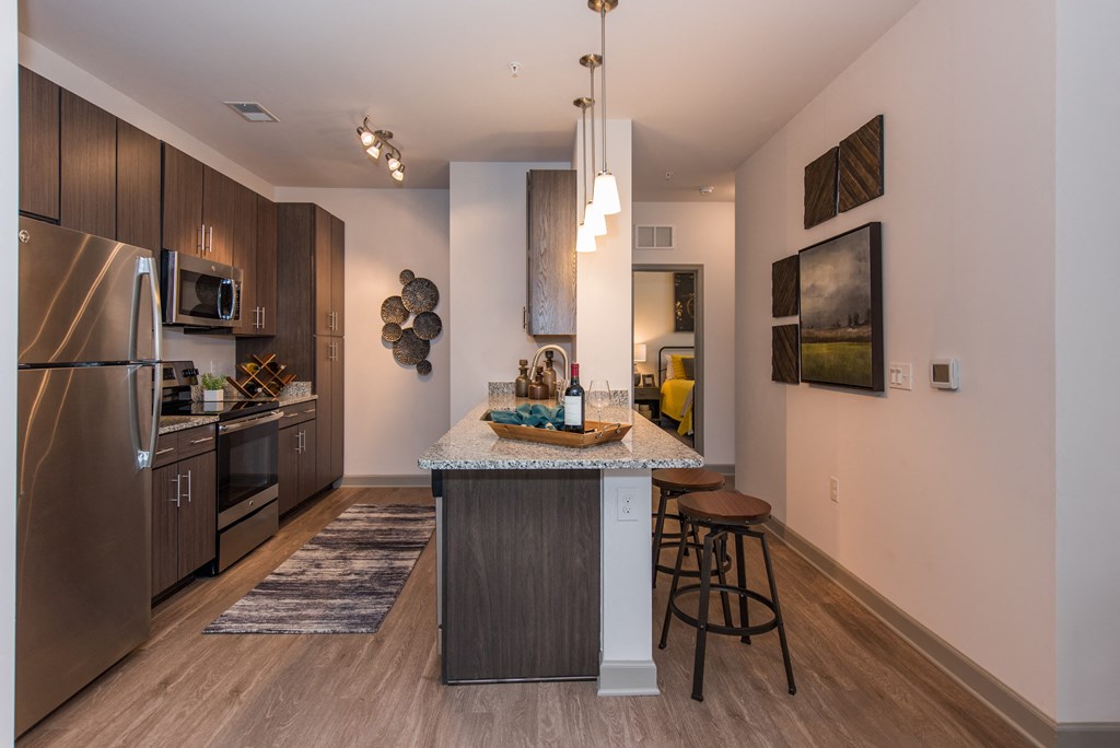 a kitchen with a large island and stainless steel appliances at The Whitworth, Williamsburg, VA, 23185