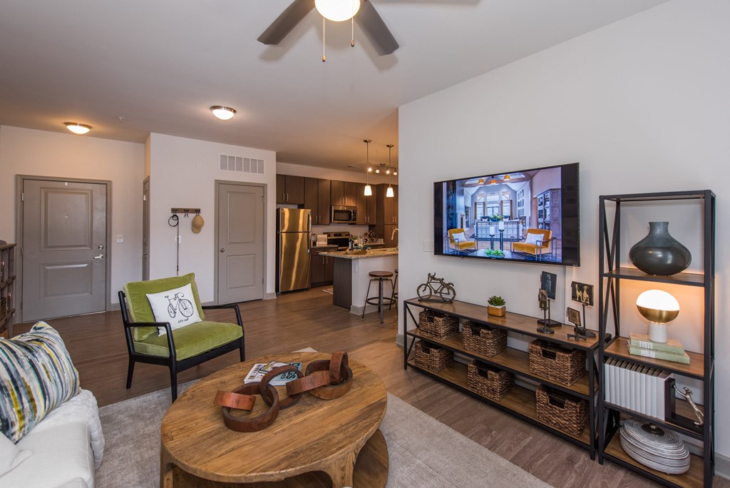 a living room with a ceiling fan and a flat screen tv at The Whitworth, Williamsburg, 23185