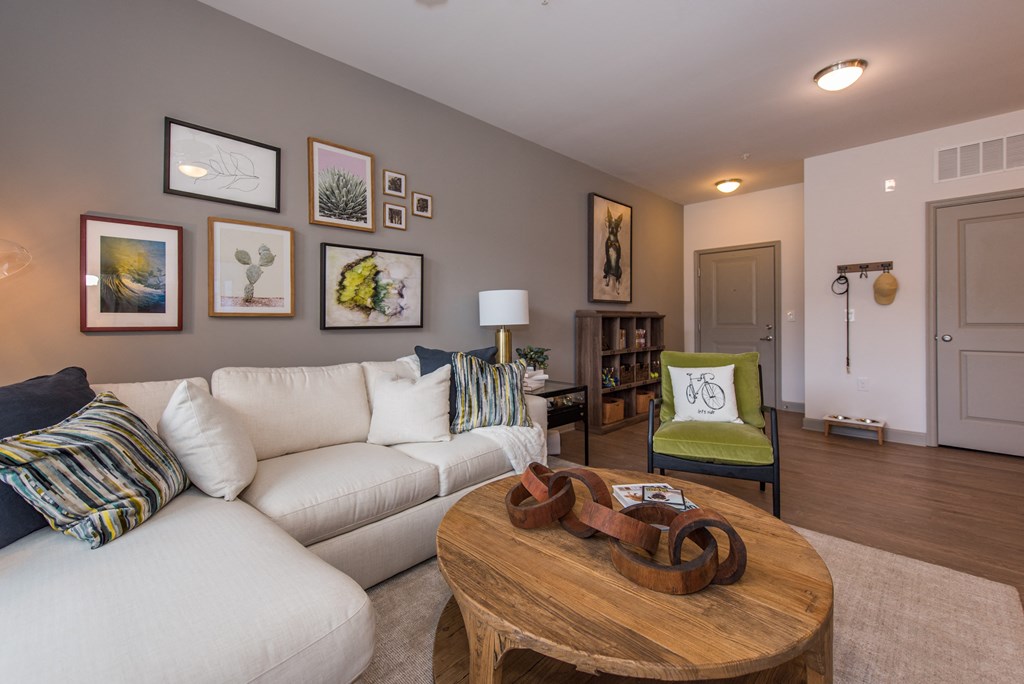 a living room with a white couch and a wooden coffee table at The Whitworth, Williamsburg, Virginia
