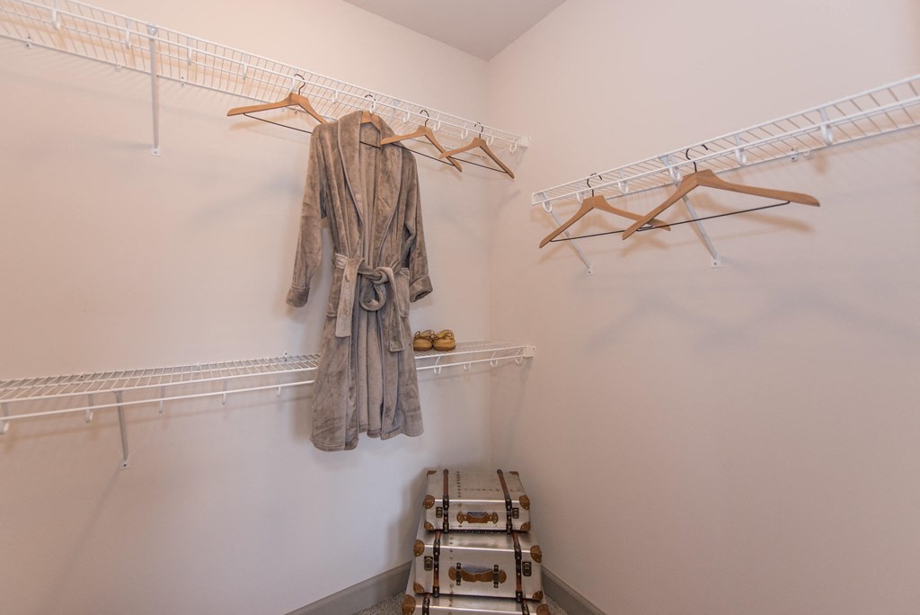 a walk in closet with a robe hanging on the wall at The Whitworth, Williamsburg, VA