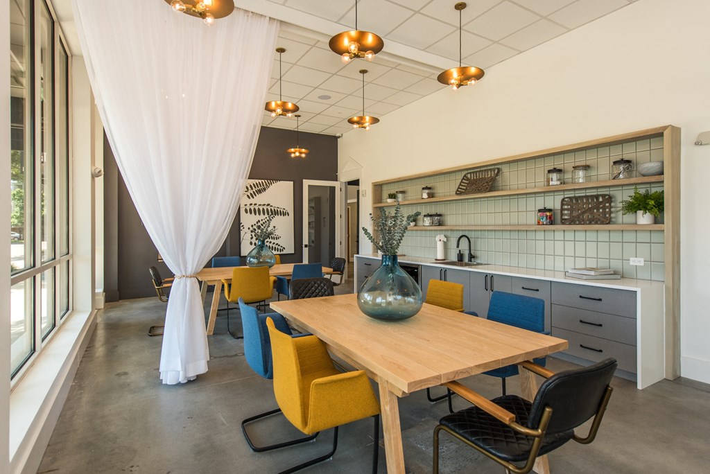 a dining room with a wooden table and yellow chairs