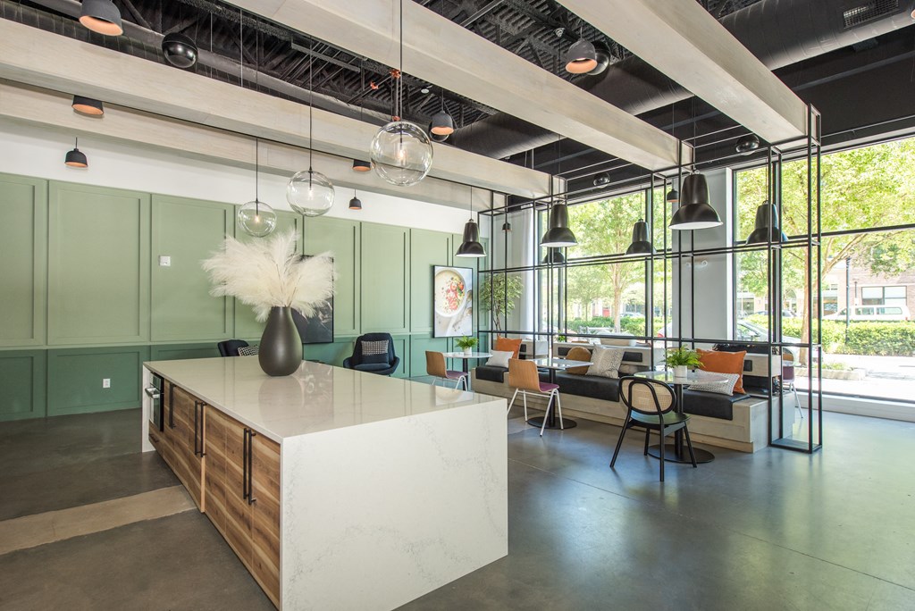 a large room with a kitchen island and a living room with couches