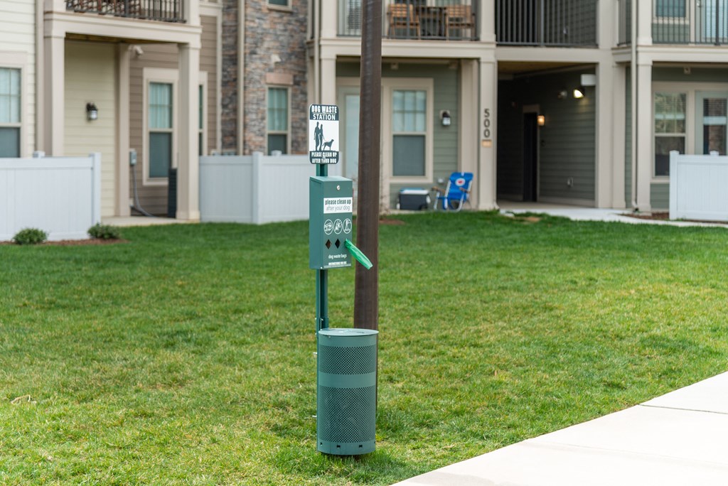 a recycling bin sits next to a pole in front of a building at The Whitworth, Virginia, 23185