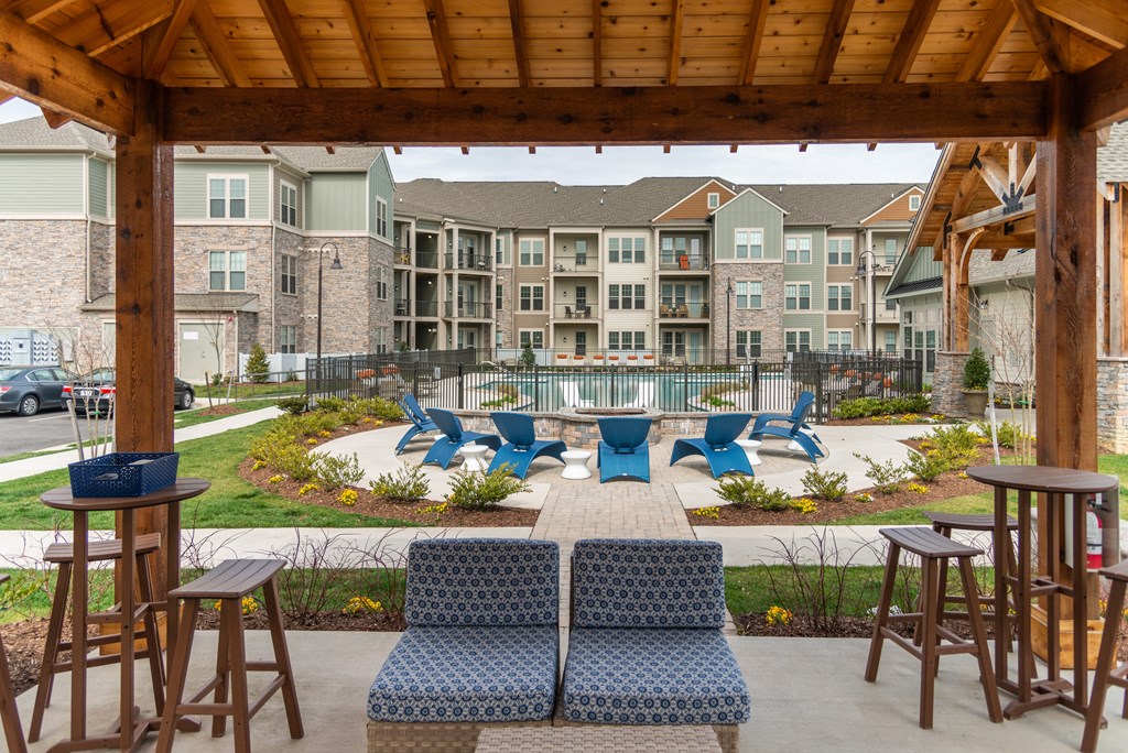 an outdoor patio with lounge chairs and tables at The Whitworth, Williamsburg, 23185