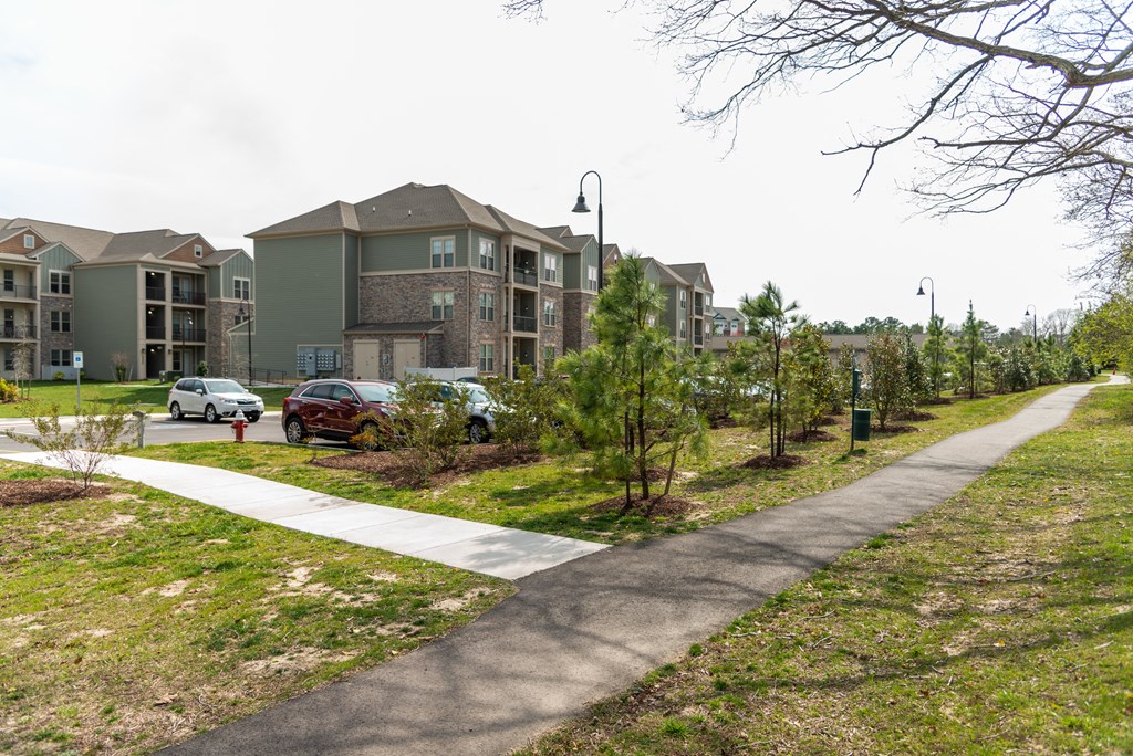 a walkway at the whispering winds apartments in pearland, tx at The Whitworth, Williamsburg, Virginia