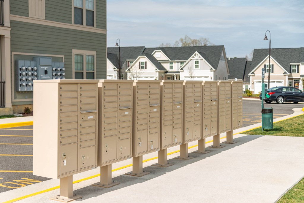 a row of mailboxes on a sidewalk in front of a house at The Whitworth, Virginia