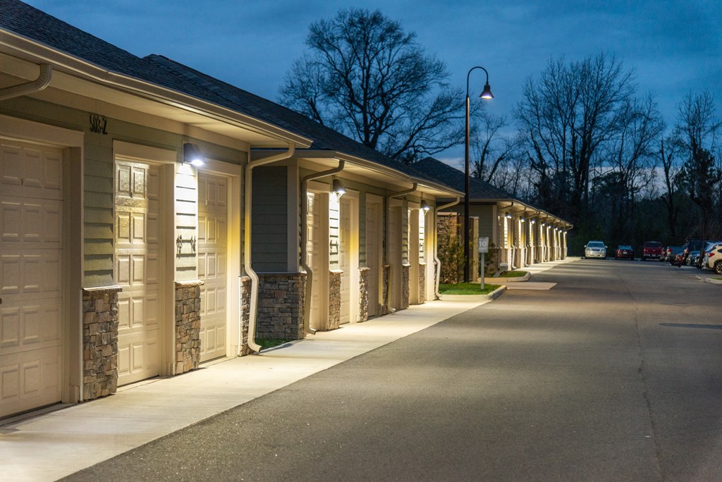 a row of buildings with white doors and shutters at The Whitworth, Williamsburg, 23185