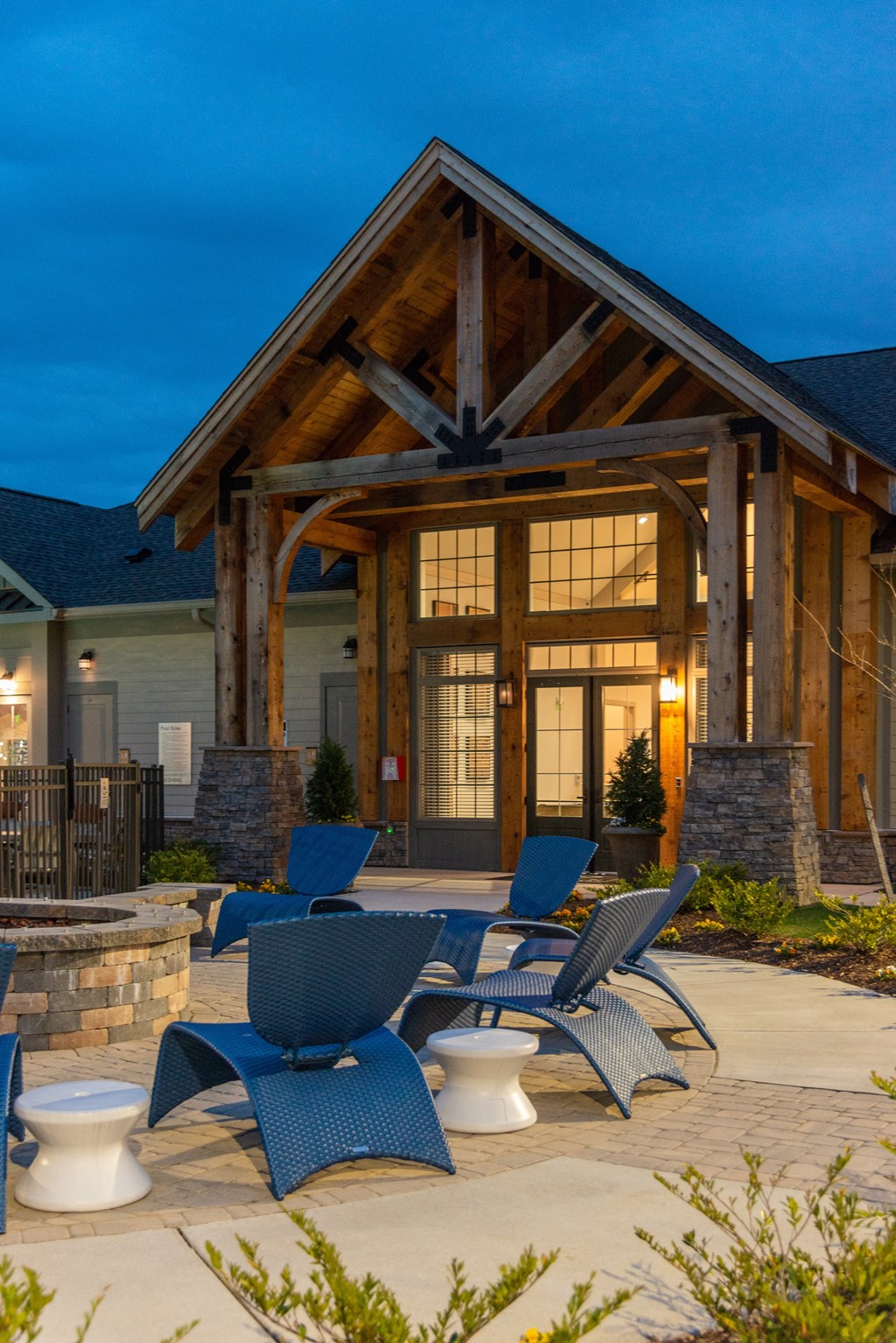 a patio with chairs and a fire pit in front of a building at The Whitworth, Williamsburg, VA