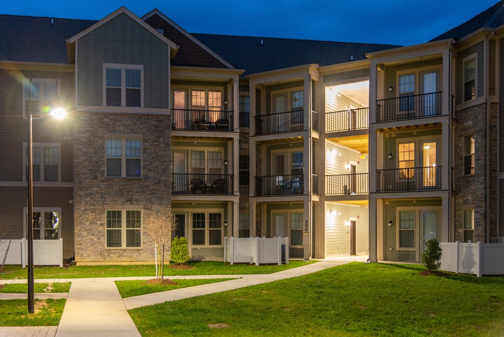 an apartment building lit up at night at The Whitworth, Williamsburg, VA