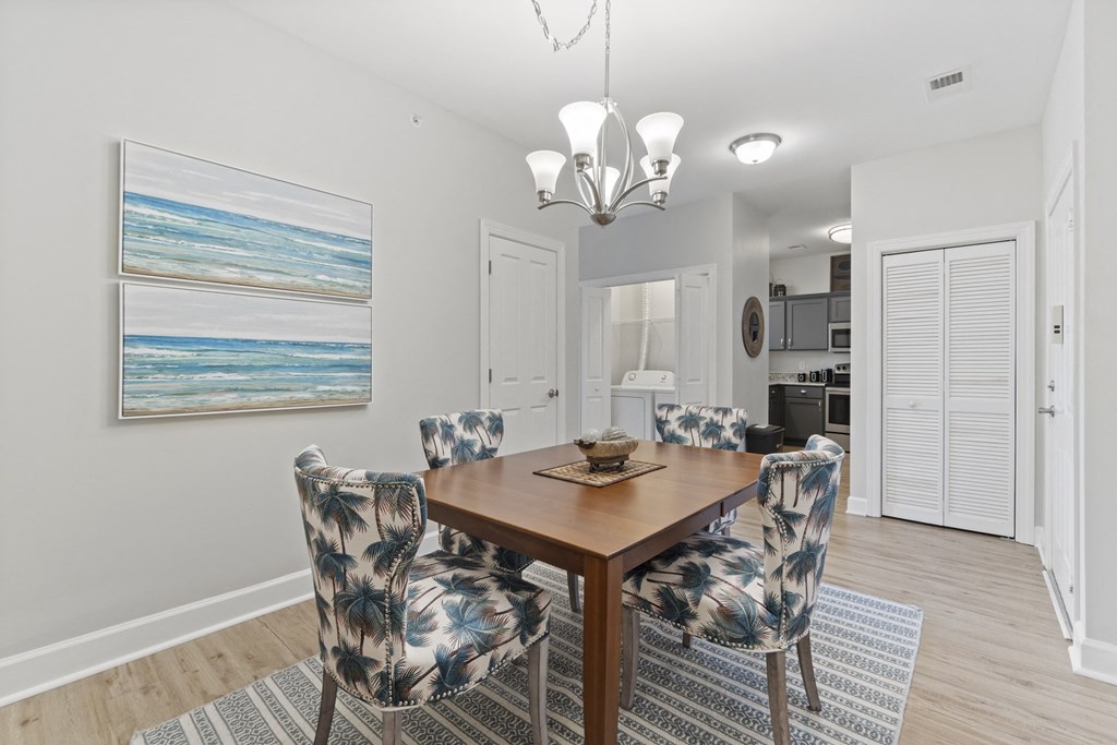 A dining room with a wooden table and chairs with a blue and white pattern at Saltmeadow Bay, Virginia Beach, Virginia