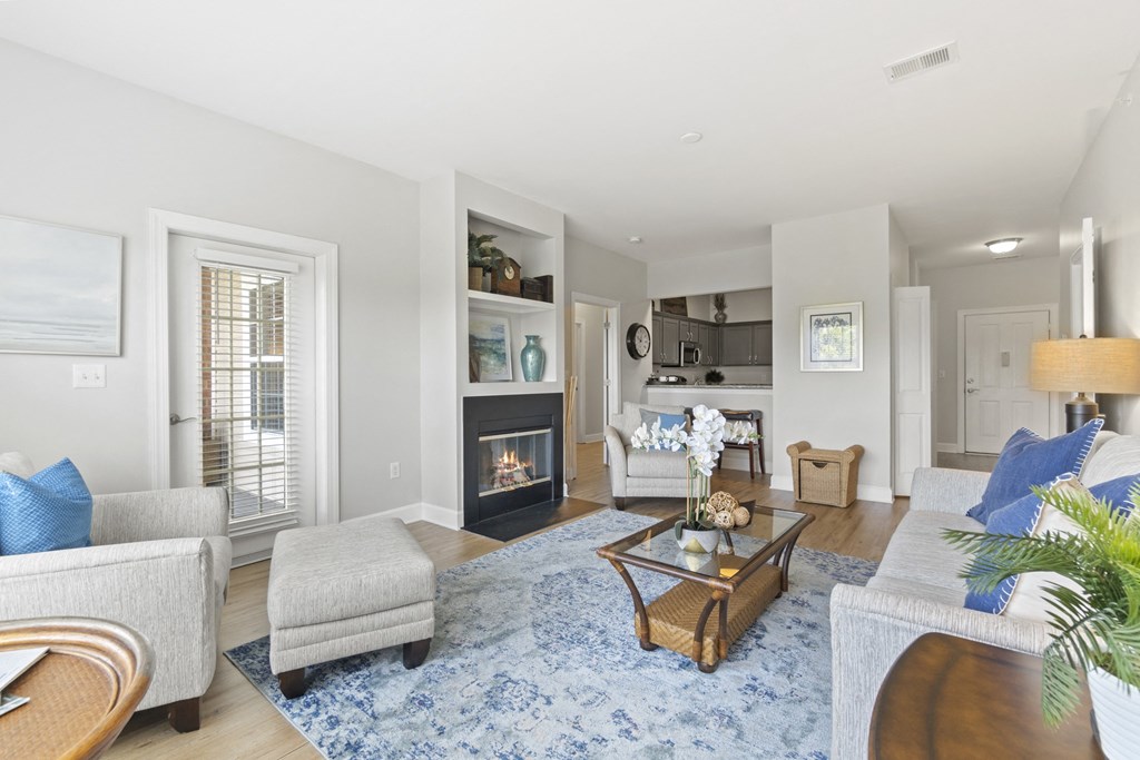 A living room with a fireplace and a blue rug at Saltmeadow Bay, Virginia Beach, VA, 23451