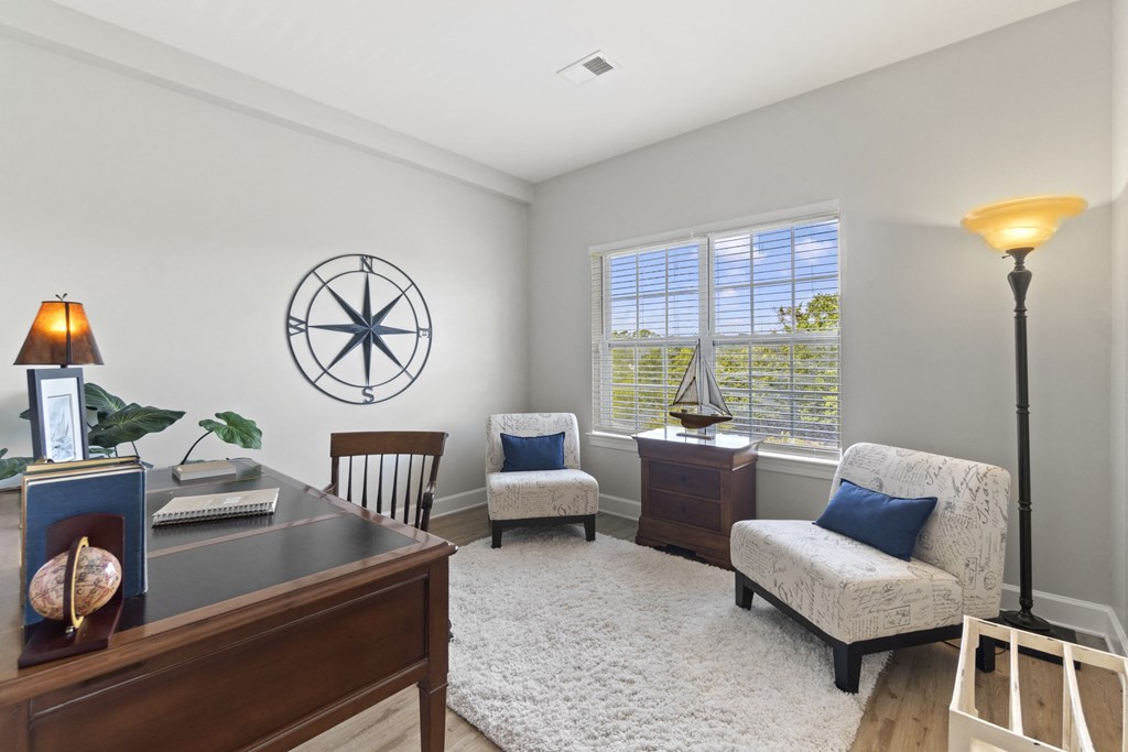 A room with a compass on the wall and a lamp on the desk at Saltmeadow Bay, VA, 23451