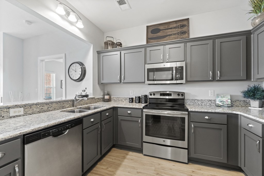 A kitchen with dark cabinets and stainless steel appliances at Saltmeadow Bay, Virginia Beach, VA, 23451