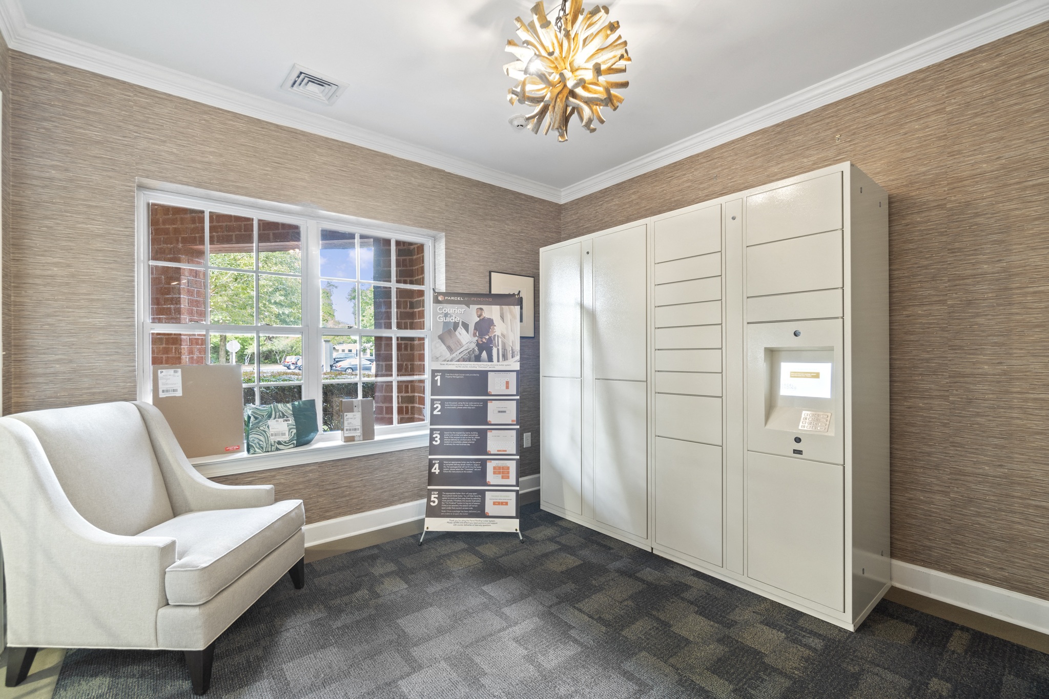 the living room has a large window and a white dresser with a white chair