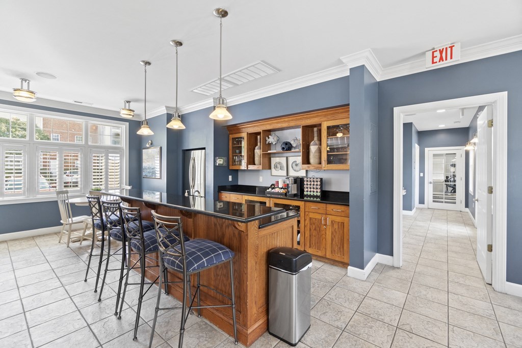 a communal kitchen with a bar and chairs in a lobby at Saltmeadow Bay, Virginia Beach, 23451