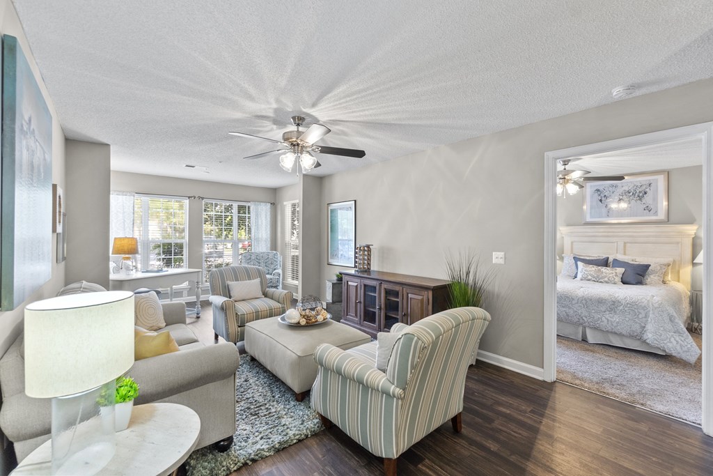 A living room with a striped armchair and a white lamp