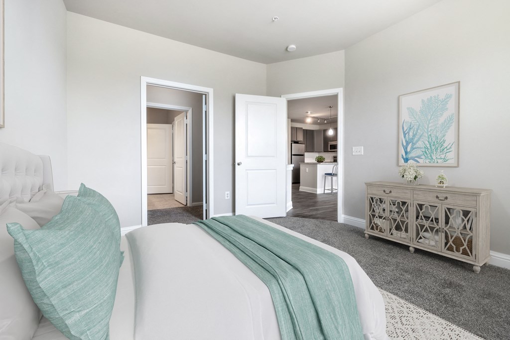 A bedroom with a white bed and a grey cabinet at Streets of Greenbrier, Chesapeake, VA, 23320